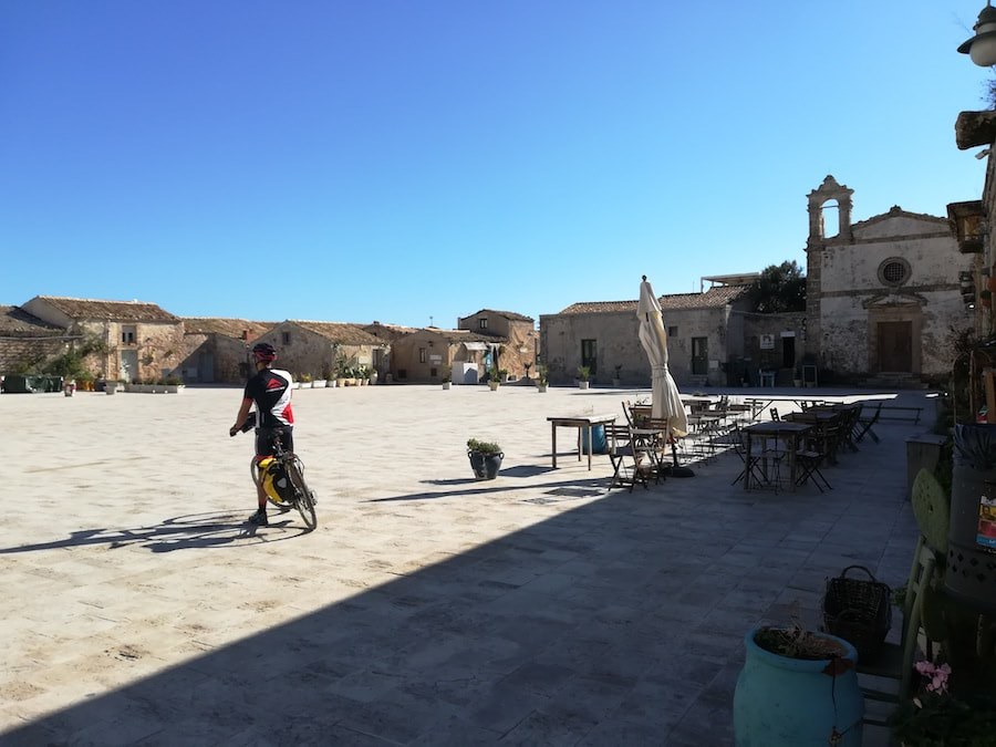 Cycliste sur la place principale du village de pêcheurs de Marzamemi